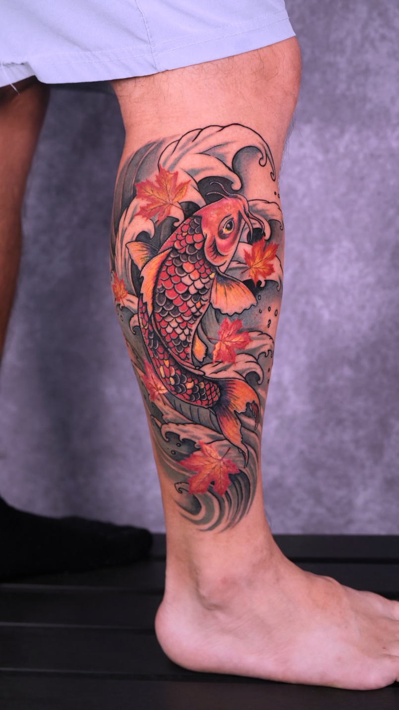Color koi fish and maple leaf leg tattoo by Eduardo Marquez