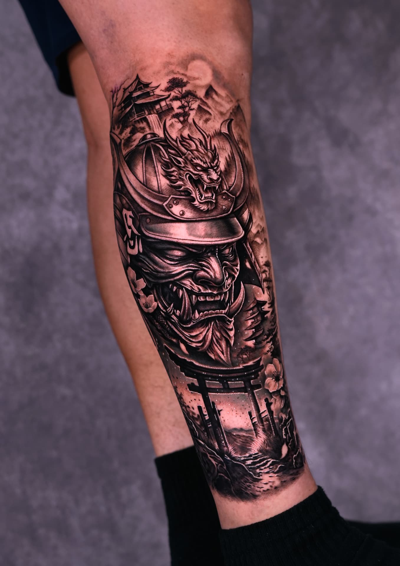 Black and grey samurai and dragon sleeve tattoo by Brayan Batista at Lions Ink