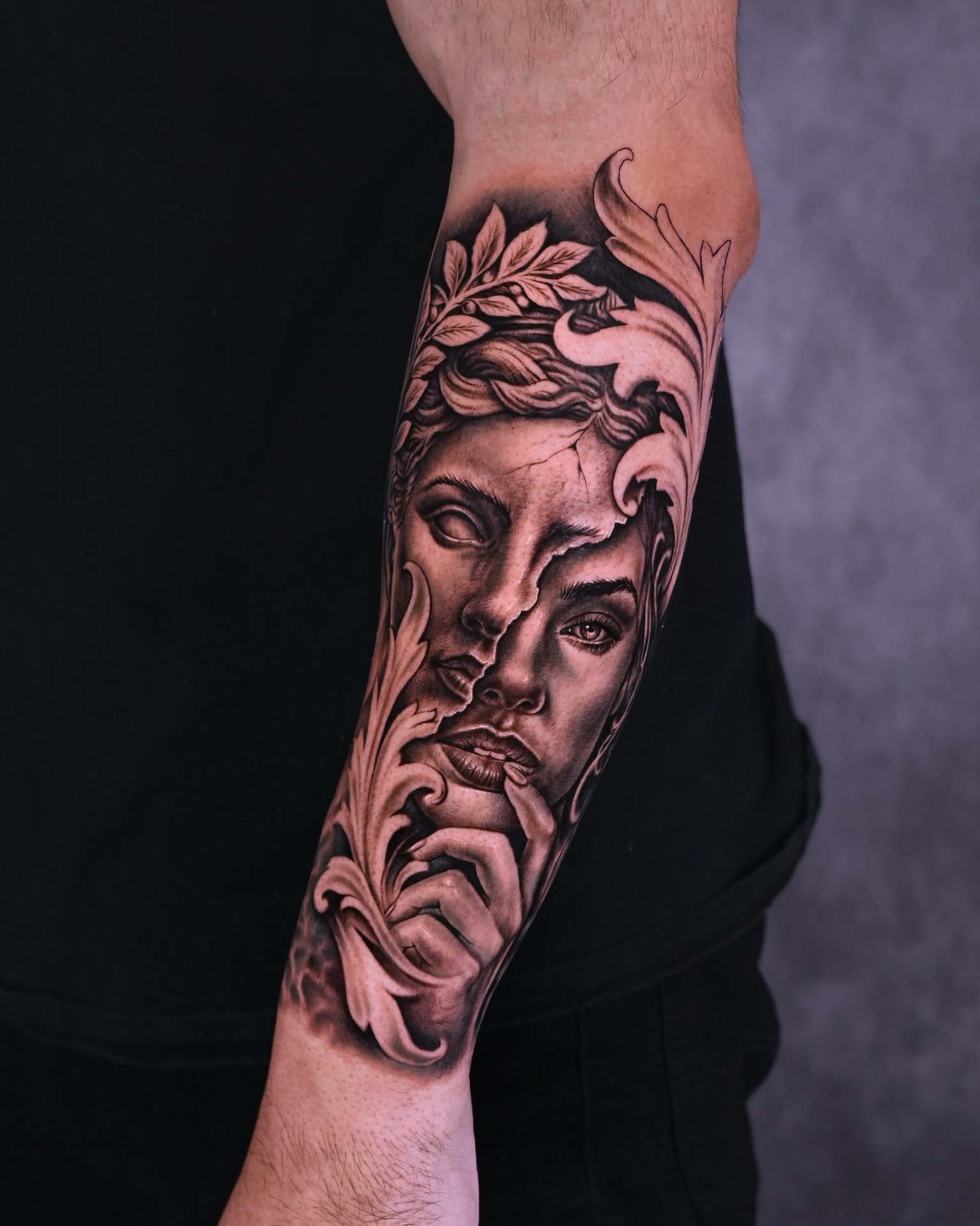 Black and grey realism split portrait and ornamental forearm tattoo by Lions Ink