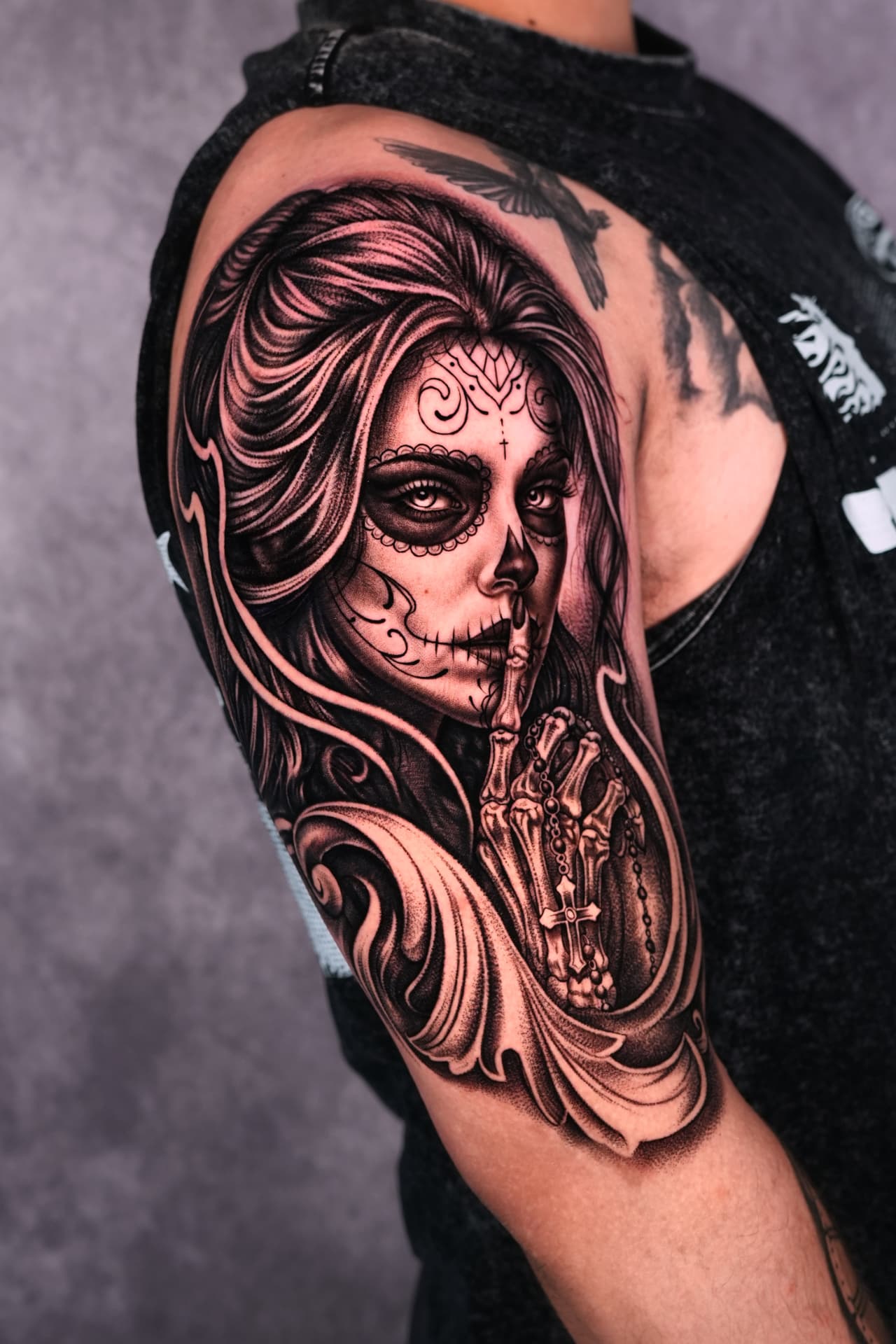 Black and grey sugar skull woman upper arm tattoo by Brayan Batista