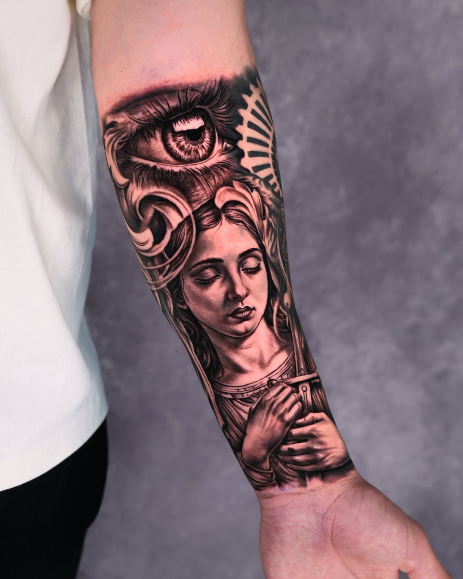 Black and grey realism eye and portrait forearm tattoo by Lions Ink in San Antonio