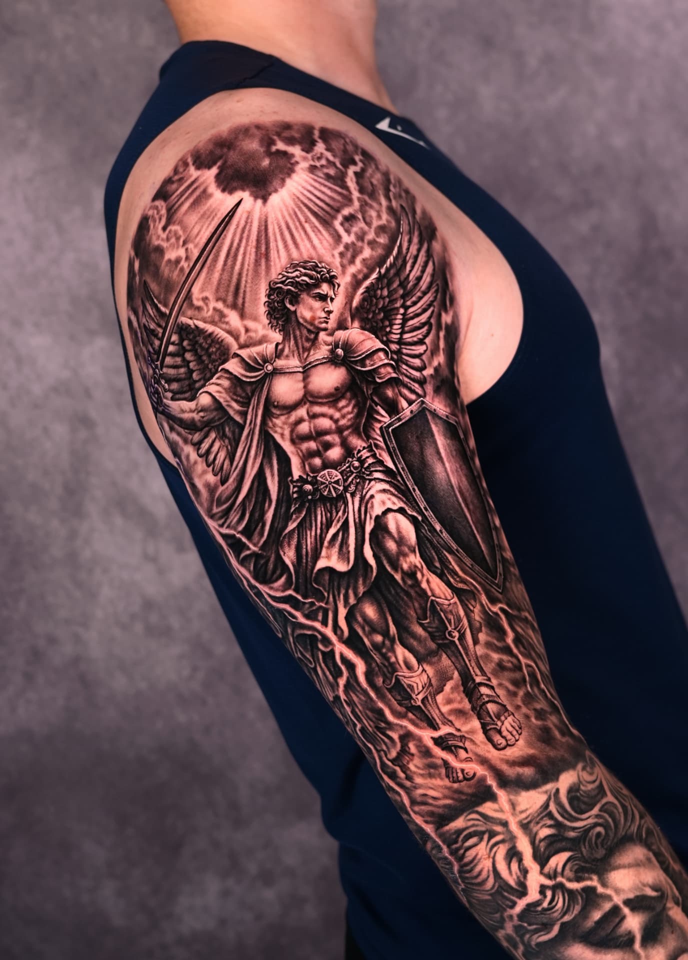 Black and grey angelic warrior sleeve tattoo by Brayan Batista