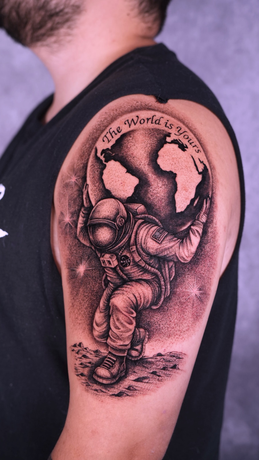 Astronaut and globe shoulder tattoo by Eduardo Marquez