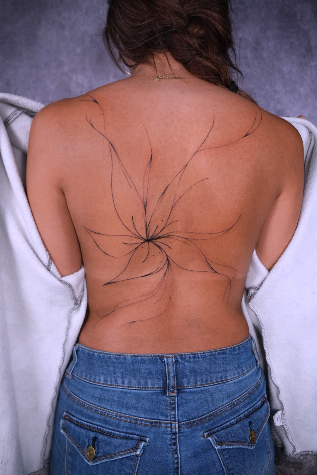 Large fine line floral back tattoo by Camila at Lions Ink San Antonio