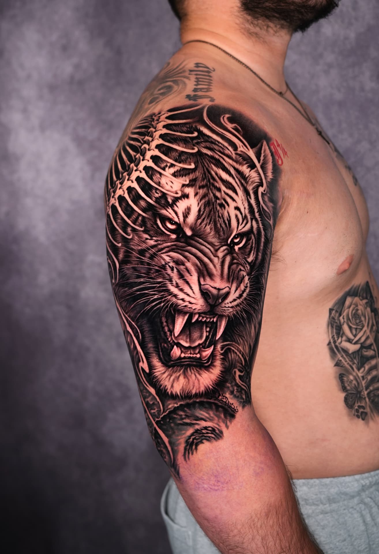 Large black and grey roaring tiger shoulder tattoo by Brayan Batista at Lions Ink San Antonio